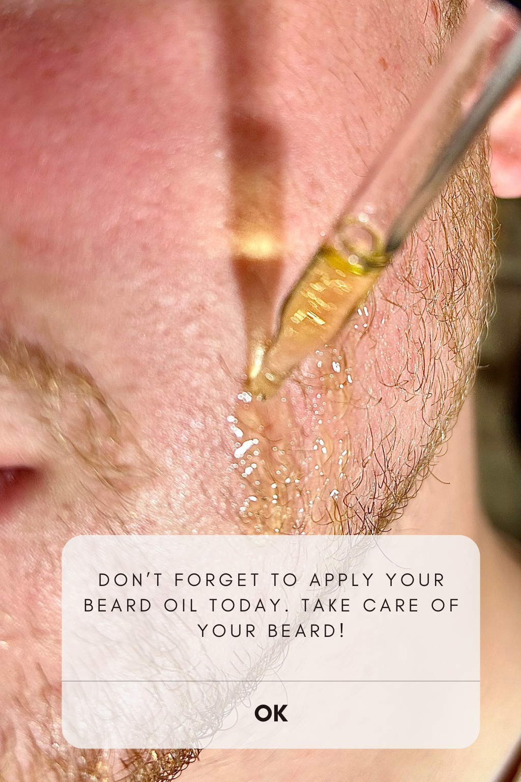 Close-up of a person applying beard oil with a dropper, text overlay encouraging beard care.