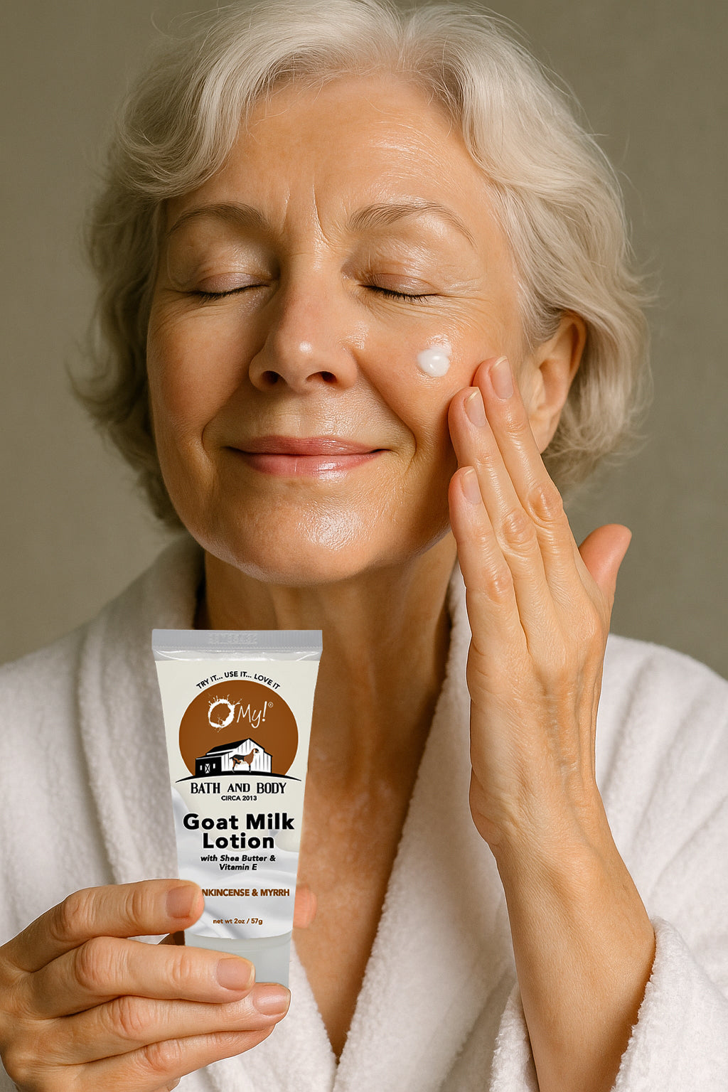 Woman applying goat milk lotion to her face with a bottle of O My! Goat Milk Lotion in hand.