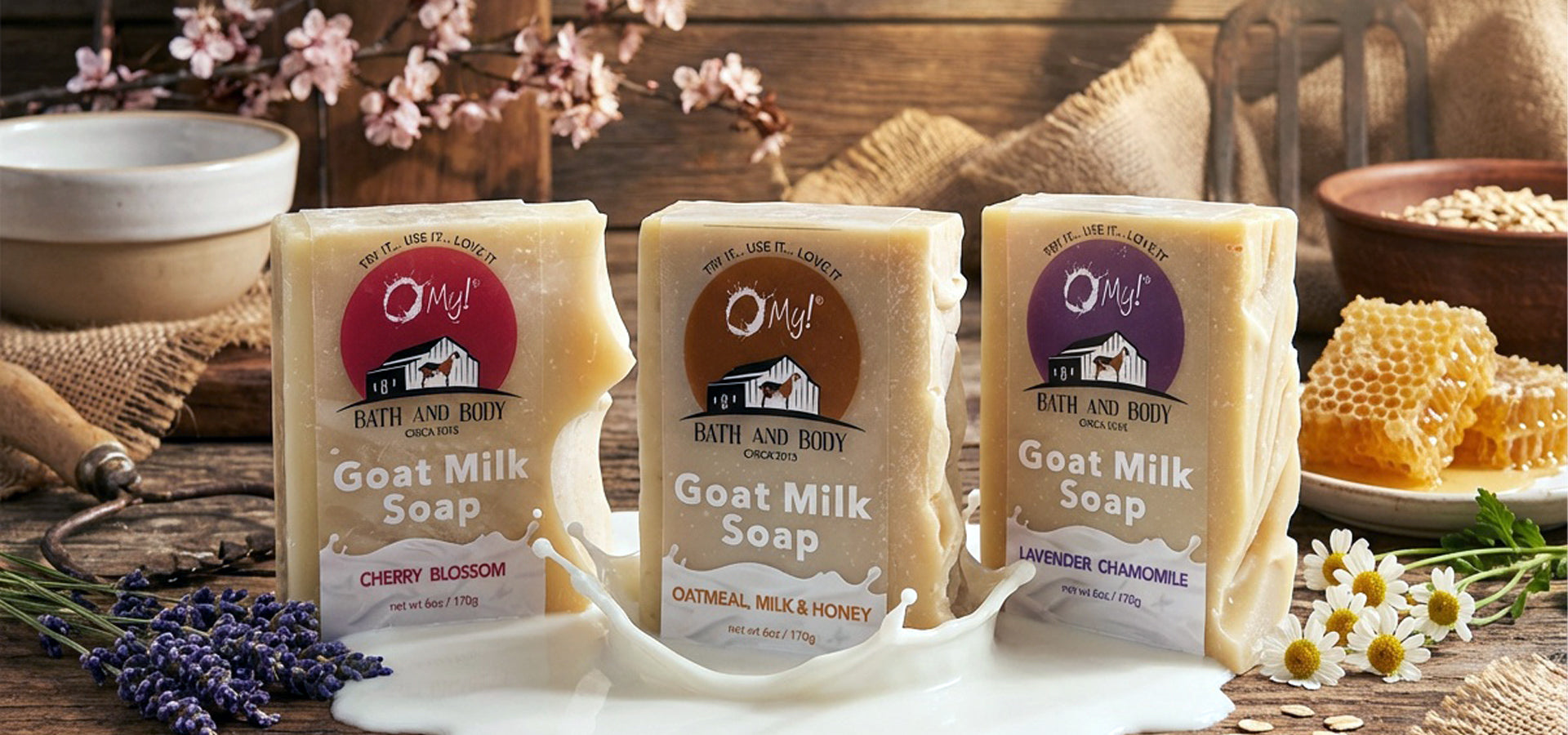 Three bars of O My! goat milk soap bars in sprint fragrances on a rustic wooden surface with flowers and honeycomb.