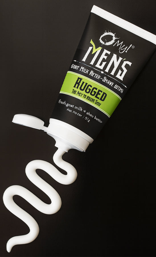 Tube of O My! Men's Goat Milk After Shave Lotion with a wavy line of lotion oozing out on a black background