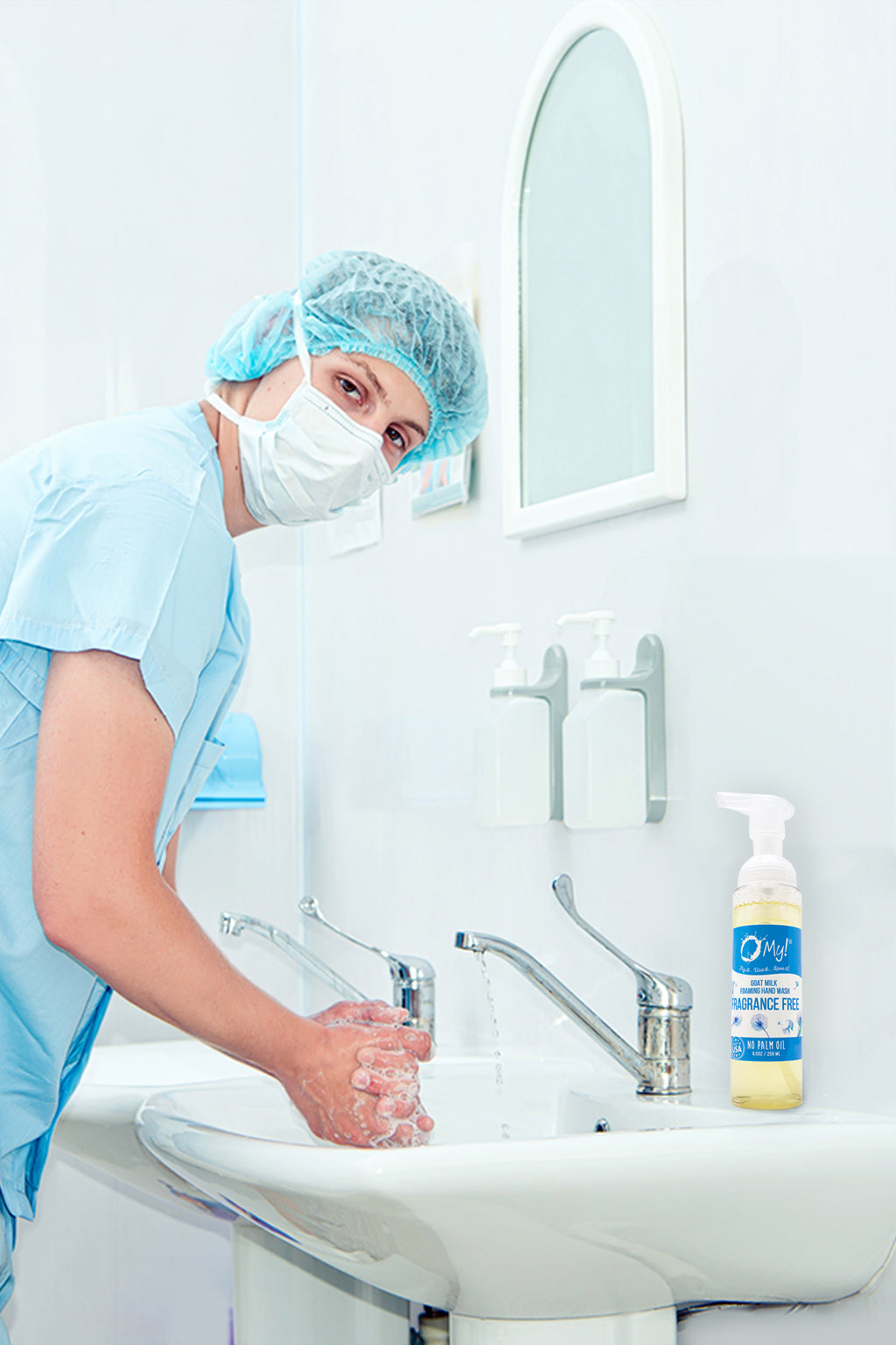 Person in surgical attire washing hands at a sink with O My! Goat Milk Foaming Hand Wash.