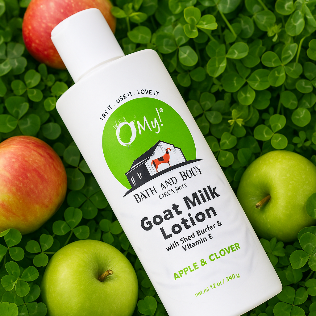 Bottle of O My! Bath and Body Goat Milk Lotion with apples on a green leaf background