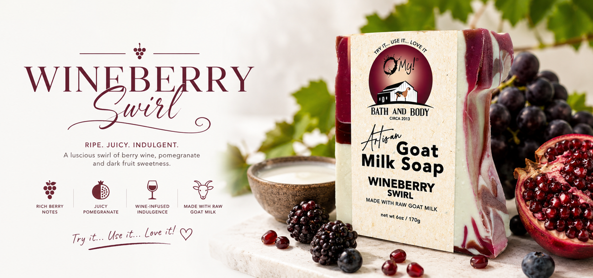 O My! Artisan Goat milk soap bar with 'Wineberry Swirl' packaging, surrounded by grapes and pomegranate seeds on a light background.
