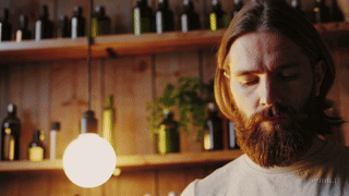 Man creating a small batch of beard oil.