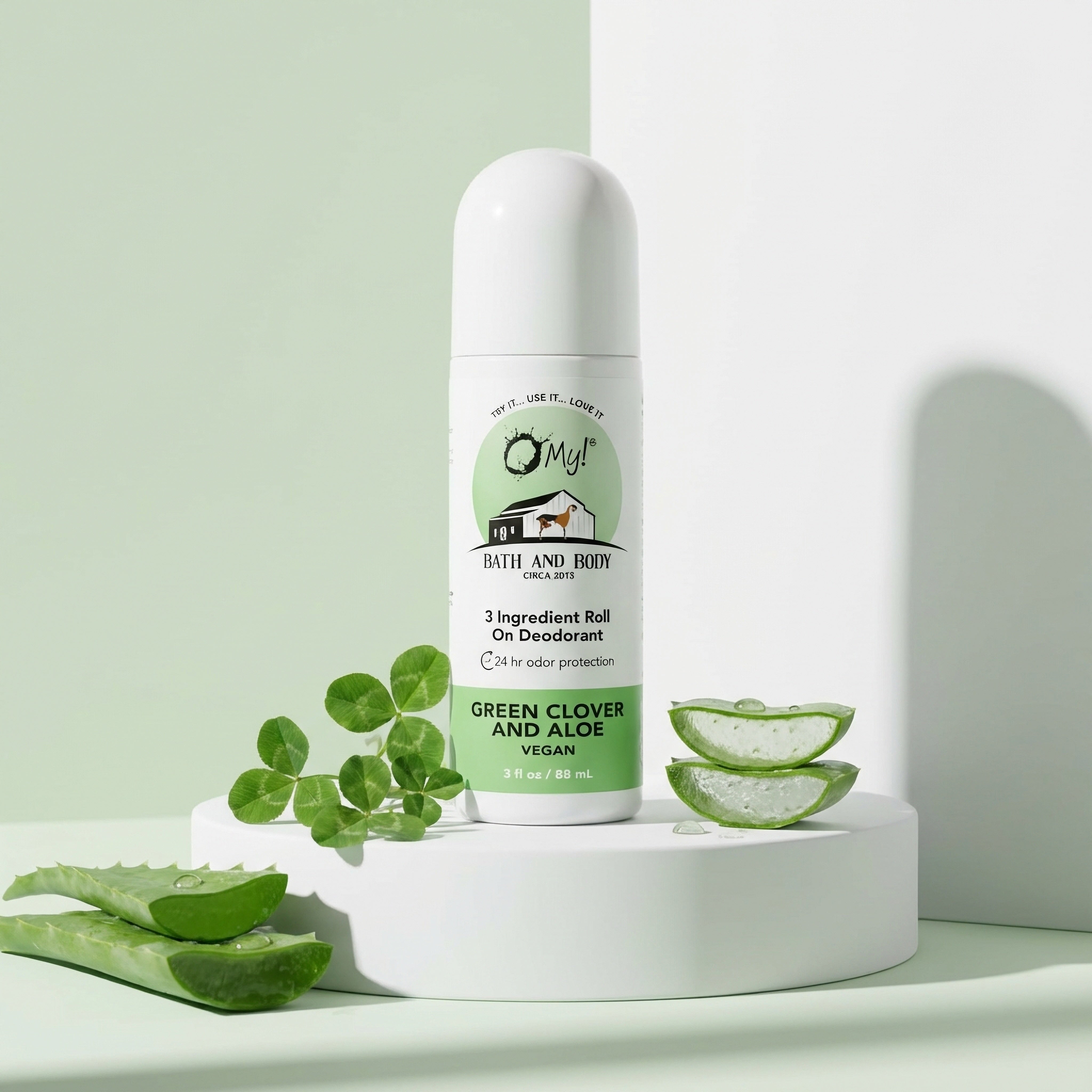 O My! 3 Ingredient Roll On Deodorant bottle on a white platform against a light green background with elements of aloe and clover around it.