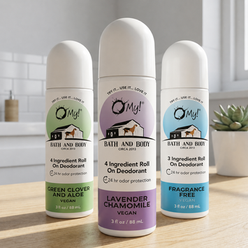 Three O'My! Bath and Body deodorant roll-on, refillable bottles on a wooden surface with a neutral background.