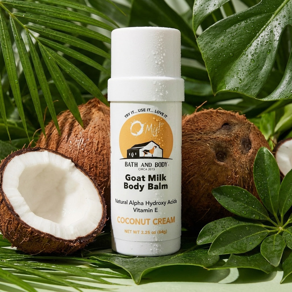 O My! Goat milk body balm Coconut Cream twist tube with coconuts and green leaves on a light green background.