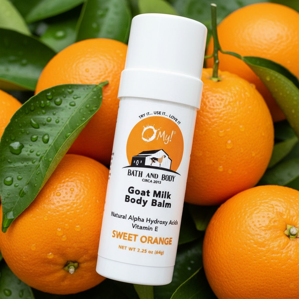 O My! Goat milk body balm Sweet Orange twist tube with oranges and green leaves on a light green background.