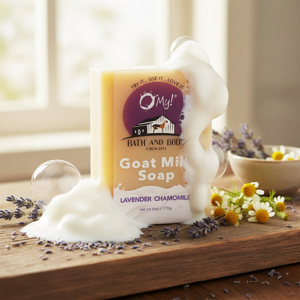 O My! Goat milk soap with lavender chamomile scent on a wooden surface with flowers and soap bubbles.