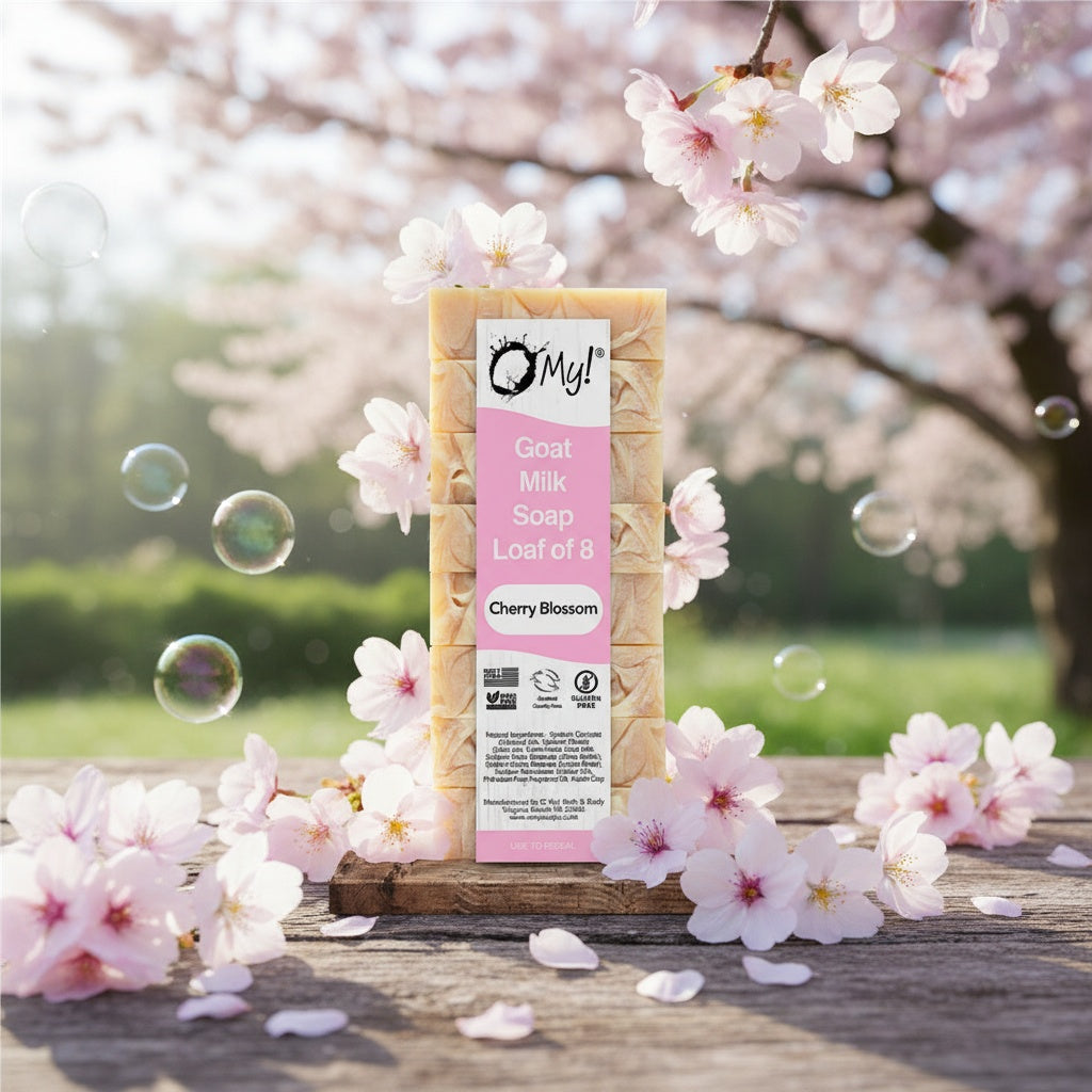 O My Cherry Blossom goat milk soap bar with packaging on a wooden surface with cherry blossoms in the background