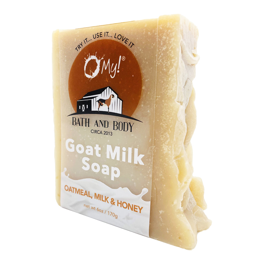 Bar of O My! goat milk soap with a clear label on a white background