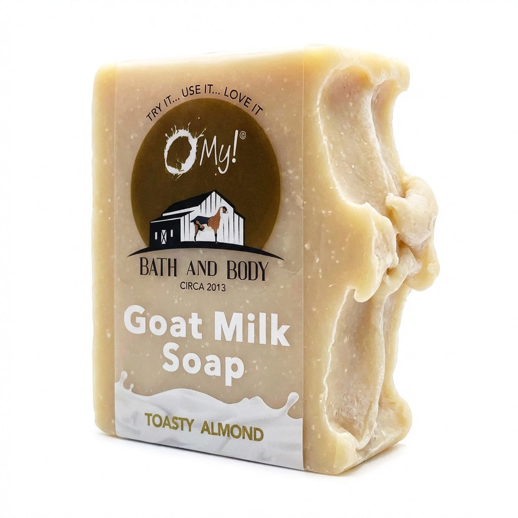 Bar of O My! goat milk soap with a clear label on a white background
