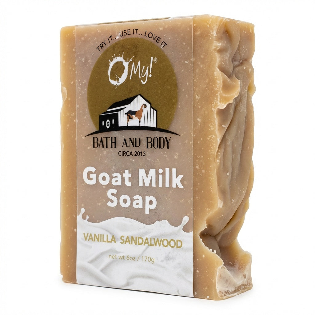 Bar of O My! goat milk soap with a clear label on a white background