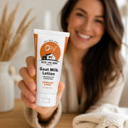 Woman holding out the traveler tube of O My! Oatmeal Milk and Honey with Vitamin E and Colloidal Oats.