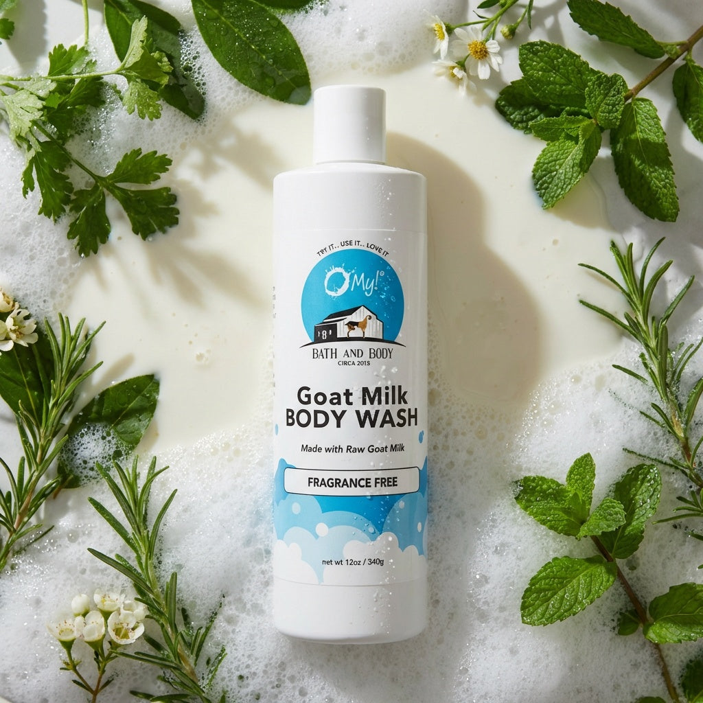 O My! Goat Milk Body Wash bottle surrounded by green leaves and plants on a milky background.