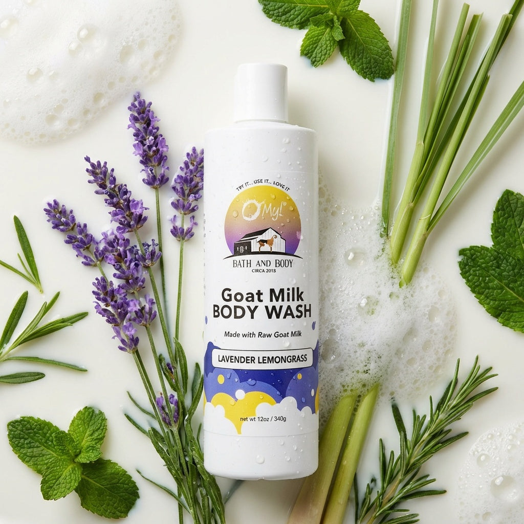 O My! Goat Milk Body Wash Lavender Lemongrass bottle surrounded by lavender and lemongrass plants on a milky background.