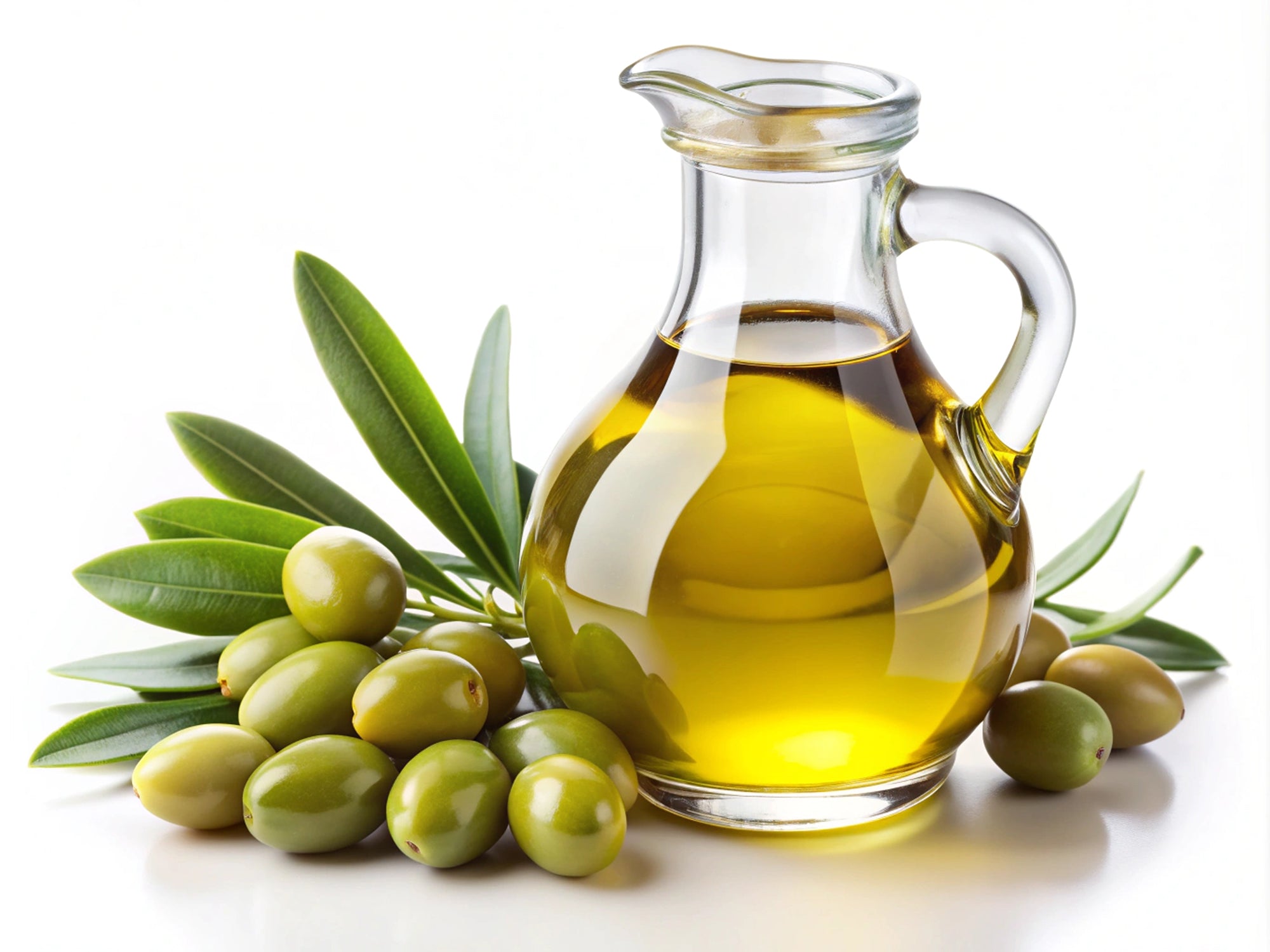 Glass jar of olive oil with green olives and leaves on a white background