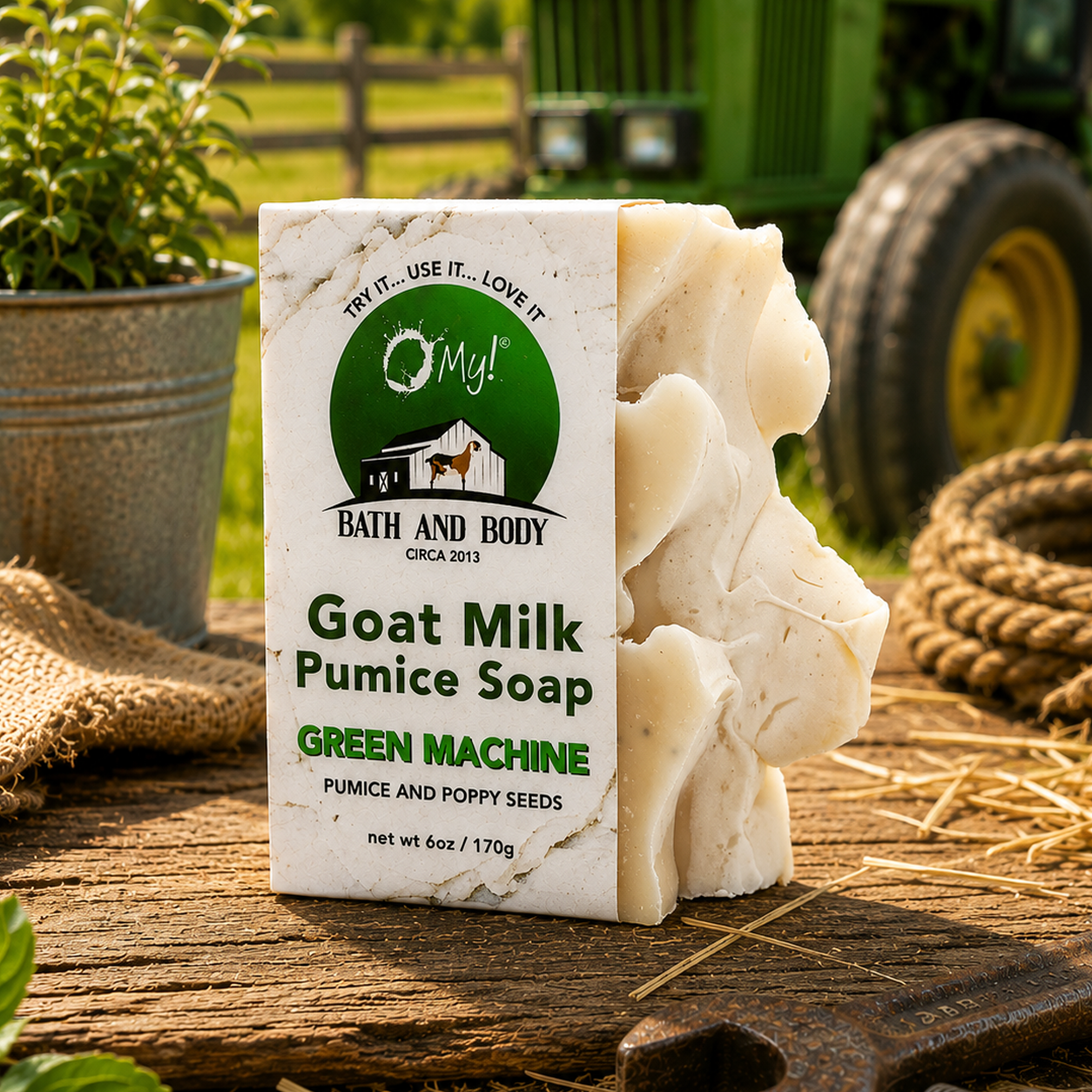 O My! Goat Milk Pumice Soap Green Machine sitting on a rustic table outdoors with a john deer tractor in the background.